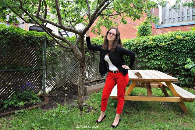 Sweet and sassy in a black cardigan, white tee, and red ankle jeans.