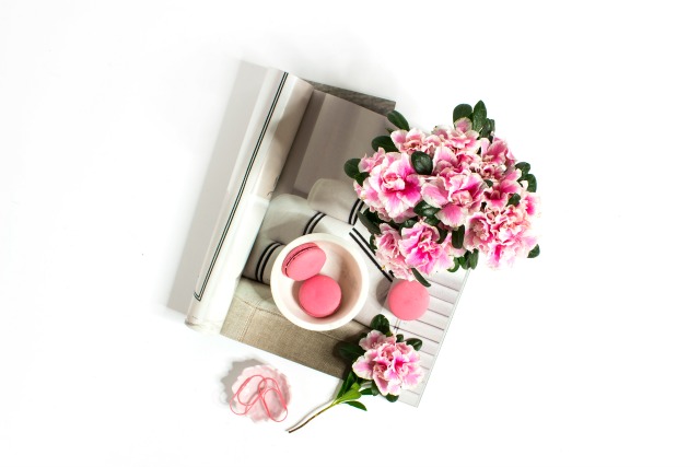 Pink flowers, pink macarons, magazine flat lay