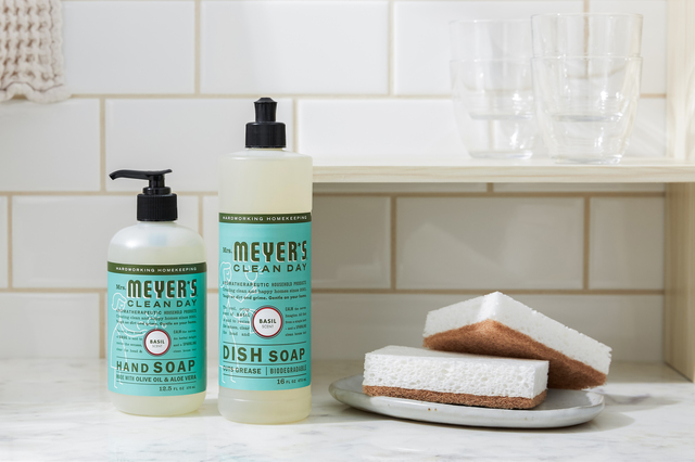 Kitchen counter with Mrs. Meyer's hand soap and dish soap beside two sponges