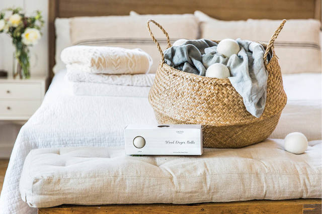 Laundry basket on bed, wool dryer balls