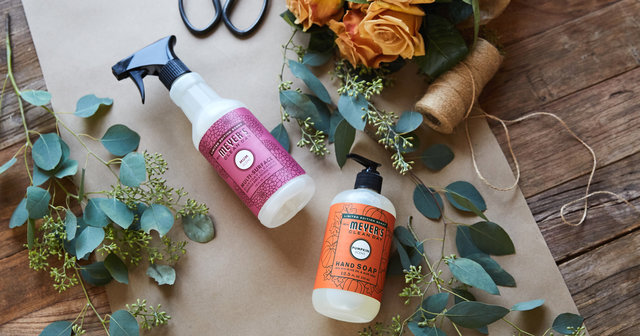 Tablescape with flowers, leaves, hand soap, and spray cleaner