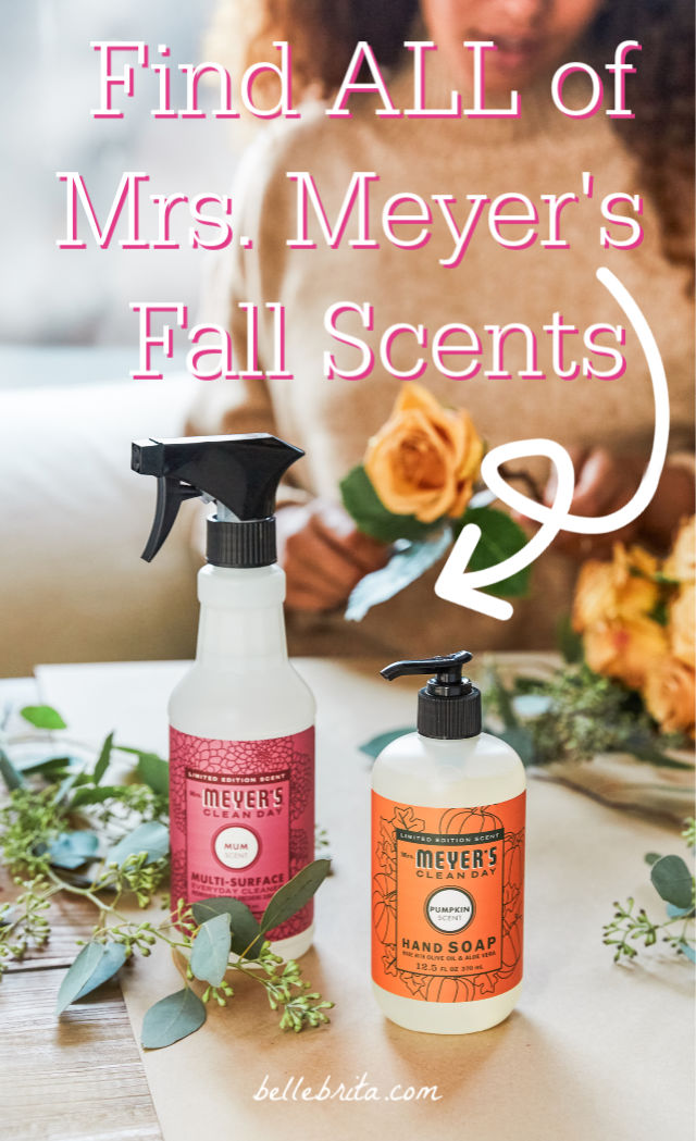 Table with flowers, hand soap, and surface cleaner. Text overlay reads: "Find ALL of Mrs. Meyer's Fall Scents"