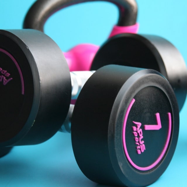 Pink and black weights against a teal background