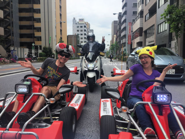 Man and woman in go-karts, man on motorcycle