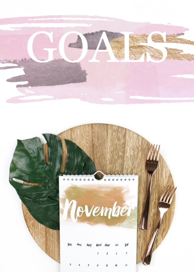 Flat lay with November calendar, wooden tray, green leaf, gold forks. Text overlay reads GOALS. 