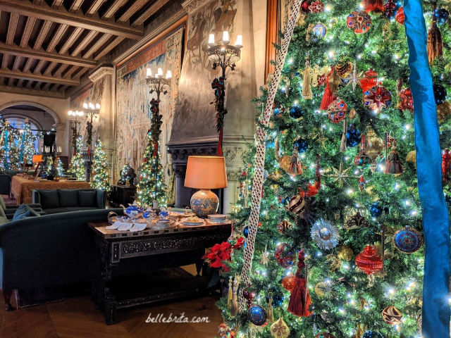 Lavishly decorated room in Biltmore, filled with Christmas trees