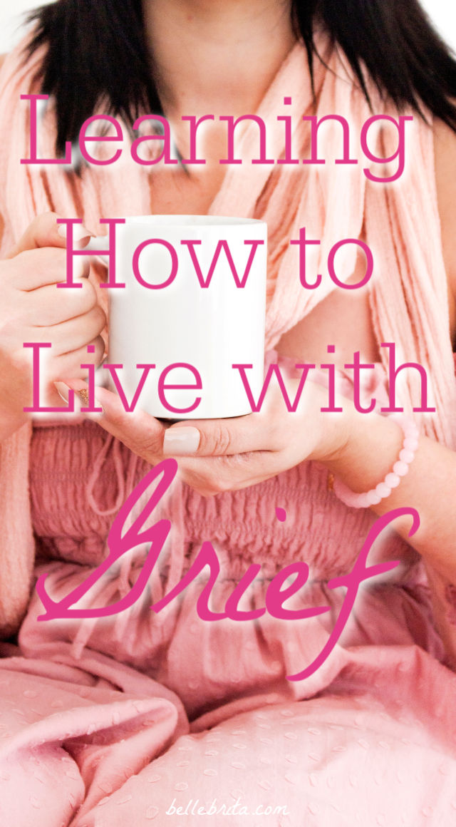 Woman in pink holding mug. Text overlay reads: "Learning How to Live with Grief"