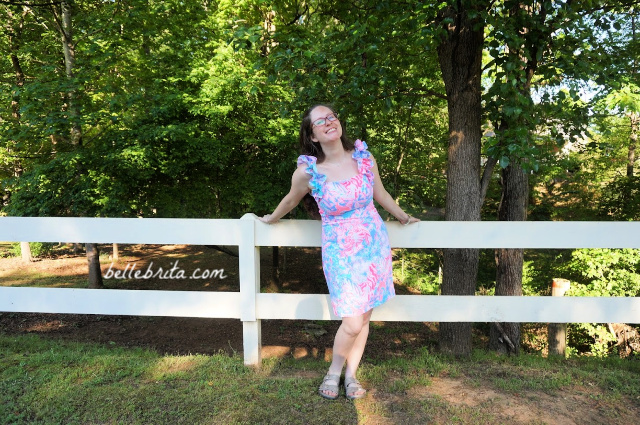 White woman wearing a pink, white, and blue Lilly Pulitzer sundress