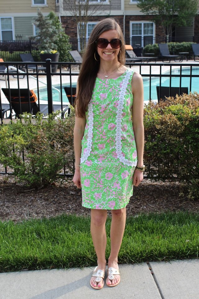 White woman wearing a pink and green Lilly Pulitzer sundress