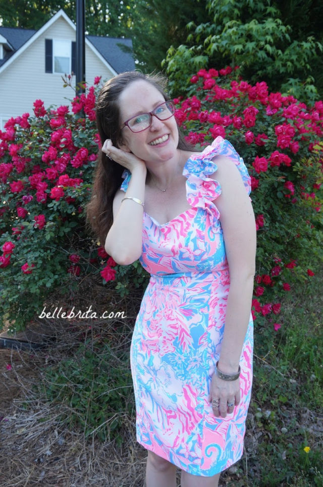 White woman wearing a pink, white, and blue Lilly Pulitzer sundress