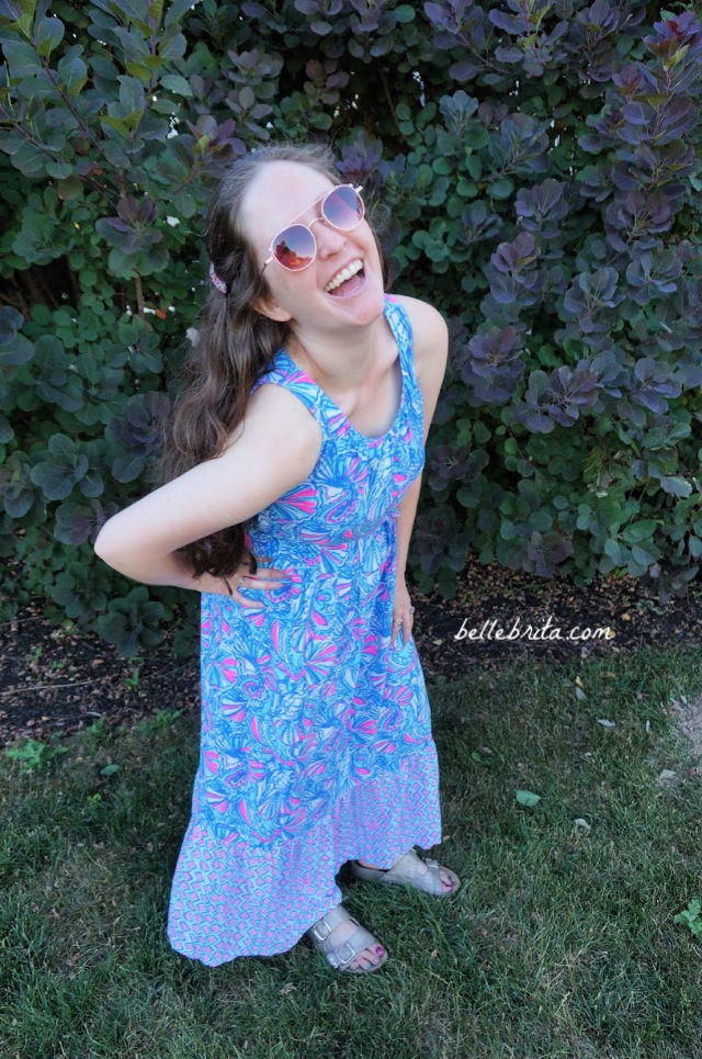 White woman wearing a blue and pink Lilly Pulitzer maxi dress