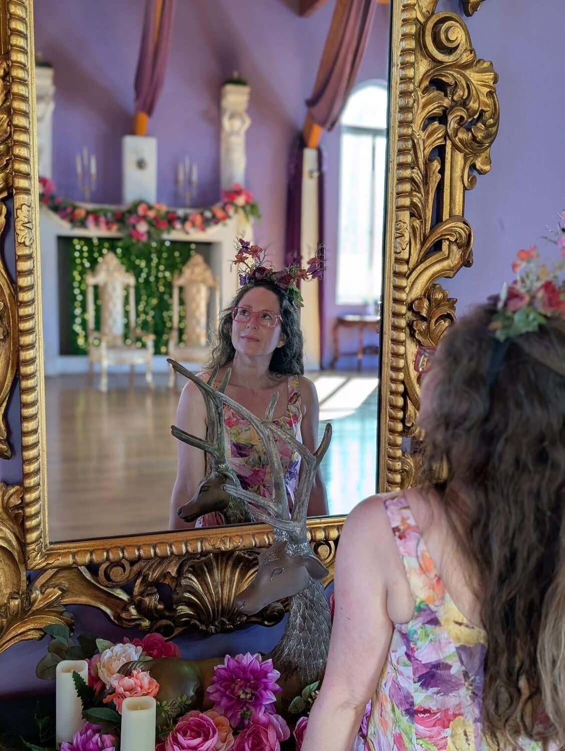 Brita Long, a Millennial white woman, looks up and to the left, her reflection shown in a gold-framed mirror. She is the founder of the blog Belle Brita.