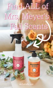 Table with flowers, hand soap, and surface cleaner. Text overlay reads: "Find ALL of Mrs. Meyer's Fall Scents"